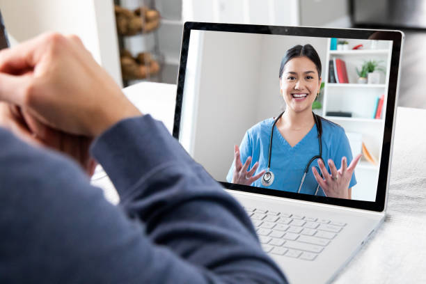 A doctor conducting a telehealth consultation with a patient via a computer.